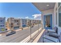 Balcony view showcasing neighborhood with chairs and metal railing, offering outdoor seating at 8076 Haywood Estate Ave, Las Vegas, NV 89113