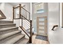 Bright foyer with stairs, modern railing, and a window providing natural light at 8076 Haywood Estate Ave, Las Vegas, NV 89113