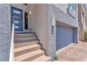 Inviting front entrance with a modern blue door and easy access to the garage at 8076 Haywood Estate Ave, Las Vegas, NV 89113