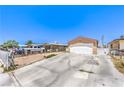 Single-story home with a concrete driveway, minimal landscaping, and an attached two-car garage at 844 Balzar Ave, Las Vegas, NV 89106