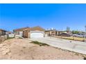 Single-story home featuring a concrete driveway leading to an attached two-car garage, complemented by minimal landscaping at 844 Balzar Ave, Las Vegas, NV 89106