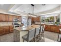 Bright kitchen with a large island, granite countertops, and stylish lighting at 9417 Grenville Ave, Las Vegas, NV 89134