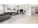 Spacious living room with a gray sectional, a large TV, and a unique geometric wall design at 1885 Vass Springs Pl, North Las Vegas, NV 89084