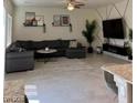 Spacious living room showcases a comfortable sectional, entertainment center, and oversized windows at 1885 Vass Springs Pl, North Las Vegas, NV 89084