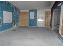 Living room featuring peeling paint, a partially boarded up wall, and painted blue trim at 1912 Statz St, North Las Vegas, NV 89030