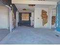 Spacious room featuring peeling paint and boarded up window at 1912 Statz St, North Las Vegas, NV 89030