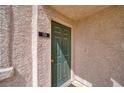 Exterior door with olive paint, brass hardware, and unit number in a well-maintained condo at 1944 Las Palmas Ln # 174, Laughlin, NV 89029