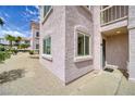 Exterior view of condo featuring desert landscaping, entry door with welcome mat, and ample sunshine at 1944 Las Palmas Ln # 174, Laughlin, NV 89029