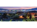Breathtaking twilight view overlooking the vibrant city skyline, from a lush greenbelt in the foreground at 20 Kittansett Loop, Henderson, NV 89052