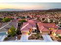 Expansive aerial view of the home nestled in a vibrant neighborhood with mountain views at 2144 Marywood Park Ct, Henderson, NV 89044