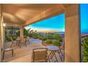 Relaxing covered patio with seating area and landscaped backyard at 2144 Marywood Park Ct, Henderson, NV 89044