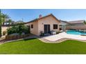 Beautiful backyard features a lawn area, patio, and planter with direct access to the home at 2200 Valley Heights Ave, Henderson, NV 89052