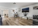 An open-concept living room with wood floors and a built-in bar area is an entertainer's dream at 2507 Albemarle Way, Henderson, NV 89014