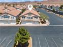 Aerial view of home showing roof, parking, desert landscaping, and quiet community at 2596 Lazy Saddle Dr, Henderson, NV 89002