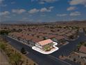 Aerial view showcases a charming neighborhood with well-maintained homes and mountain views at 2596 Lazy Saddle Dr, Henderson, NV 89002