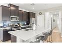 Modern kitchen featuring stainless steel appliances, a center island with seating, and sleek countertops at 295 Callen Falls Ave # 2225, Henderson, NV 89011