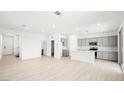 Large living space with wood-look floors and views into the open kitchen and backyard at 336 Taylor St, Henderson, NV 89015