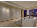 Bright living room with hardwood floors, a comfortable sofa, and floor to ceiling windows with a city view at 3750 S Las Vegas Blvd # 3111, Las Vegas, NV 89158