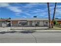 Charming single-story home with a gravel yard and mature palm trees at 4067 E Colorado Ave, Las Vegas, NV 89104