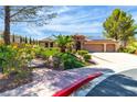 Beautiful one-story home showcasing a three-car garage, solar panels, and a well-kept lawn at 4196 Balmoral Castle Ct, Las Vegas, NV 89141