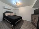 Cozy bedroom with hardwood-style floors and a modern ceiling fan at 460 Elm Dr # 103, Las Vegas, NV 89169