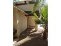 Side view showing a walkway around the house and desert landscaping at 4760 Woodridge Rd, Las Vegas, NV 89121