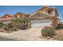Inviting home exterior with a wide driveway, desert landscaping, and a well-maintained two-car garage at 4832 Englewood Ave, Las Vegas, NV 89139