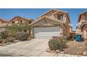 Comfortable home featuring a two-car garage, tidy landscaping, and a welcoming facade at 4832 Englewood Ave, Las Vegas, NV 89139