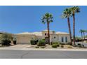 Inviting single-story home featuring a three-car garage, a tile roof, palm trees, and well-manicured landscaping at 4845 Santo Romeo St, Las Vegas, NV 89135