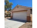 Charming single story home featuring desert landscaping and a two-car garage at 5043 Naff Ridge Dr, Las Vegas, NV 89131