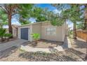 Well-maintained single-story home with desert landscaping, mature trees, and a two-car garage at 542 Grimsby Ave, Henderson, NV 89014