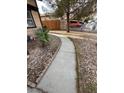 Gated side yard featuring low-maintenance landscaping and a concrete walkway at 542 Grimsby Ave, Henderson, NV 89014