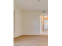 Bright hallway with beautiful floors and neutral paint, leading to the kitchen area at 5424 Comchec Way # 105, Las Vegas, NV 89108