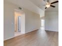 Living room with beautiful floors, neutral paint, a ceiling fan, and vaulted ceilings adds architectural interest at 5424 Comchec Way # 105, Las Vegas, NV 89108