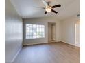 Bright living room with hardwood floors, a ceiling fan, and large windows that provide plenty of natural light at 5424 Comchec Way # 105, Las Vegas, NV 89108