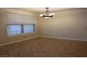 Cozy dining area features tile floors, chandelier lighting, and natural light from a window at 5855 Valley Dr # 1070, North Las Vegas, NV 89031