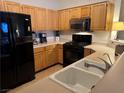 Well-equipped kitchen features warm wood cabinetry, modern appliances, and durable countertops at 5855 Valley Dr # 1070, North Las Vegas, NV 89031
