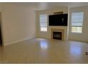 Bright living room with a cozy fireplace, neutral walls, tile flooring, and large windows for natural light at 5855 Valley Dr # 1070, North Las Vegas, NV 89031
