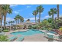 Enjoy the community pool surrounded by lush palm trees and comfortable lounge chairs for relaxation at 5855 Valley Dr # 1070, North Las Vegas, NV 89031