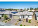 Well-kept single-story home with a tile roof, desert landscaping, and a paver driveway at 6432 Linden St, North Las Vegas, NV 89086