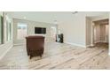 Bright living room featuring hardwood floors, ample natural light, and a modern TV setup at 6432 Linden St, North Las Vegas, NV 89086