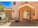 Close up of the front door and entrance of a two-story tan home at 6747 Gold Yarrow St, Las Vegas, NV 89148