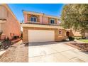 Two-story tan home with a two-car garage and desert landscaping at 6747 Gold Yarrow St, Las Vegas, NV 89148