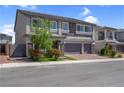 Charming two-story home showcasing a stone facade, three-car garage, and manicured landscaping at 7260 Grace Estate Ave, Las Vegas, NV 89113