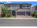 Beautiful home featuring a three-car garage, stone accents, neutral paint, and manicured landscaping at 7260 Grace Estate Ave, Las Vegas, NV 89113