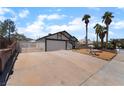 Single-story home with a two-car garage, long driveway, and desert landscaping in front at 806 Fireweed Dr, Henderson, NV 89002