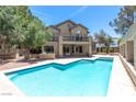 Backyard featuring a sparkling in-ground pool and patio area, perfect for entertaining at 8800 Cortile Dr, Las Vegas, NV 89134