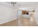 Open-concept living room with wood flooring flows into the adjacent kitchen at 9053 Entrancing Ave, Las Vegas, NV 89149