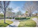 Well-maintained community area featuring a gazebo, lush lawn, and walking paths at 9140 Entrancing Ave, Las Vegas, NV 89149