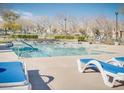Community pool with lounge chairs, perfect for relaxation and recreation at 9140 Entrancing Ave, Las Vegas, NV 89149